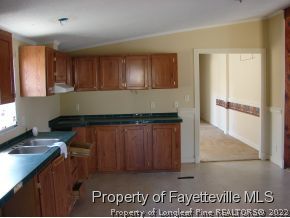 272 Line Road Cameron, NC 28326 - Photo 10 of 25 a kitchen with granite countertop a refrigerator and a stove top oven