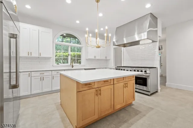 a kitchen with a stove a sink and a refrigerator