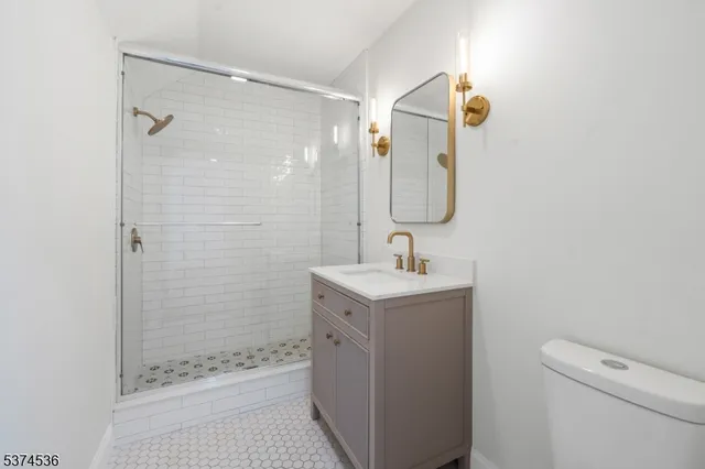 a bathroom with a toilet a sink and shower