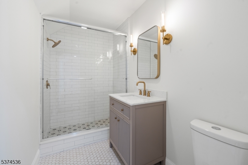 201 Dryden Road Bernardsville, NJ 07924 - Photo 25 of 48 a bathroom with a shower sink and mirror