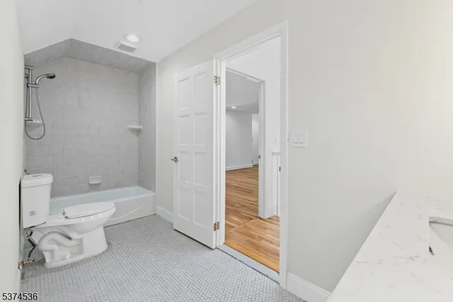 a view of a small space with wooden floor and white walls