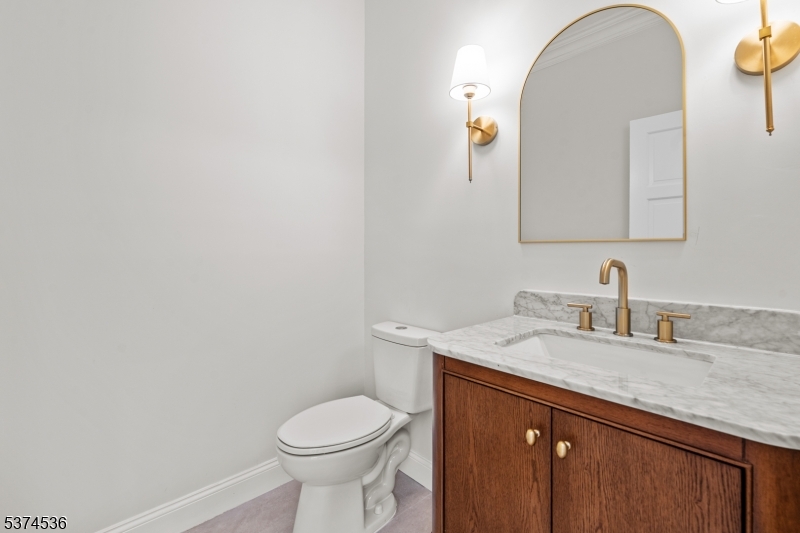 201 Dryden Road Bernardsville, NJ 07924 - Photo 28 of 48 a bathroom with a granite countertop toilet sink and mirror