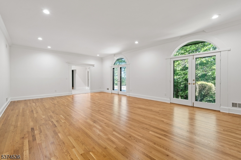 201 Dryden Road Bernardsville, NJ 07924 - Photo 3 of 48 a view of an empty room with wooden floor and a window