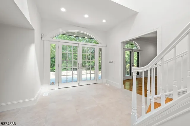 a view of a room with furniture and large windows