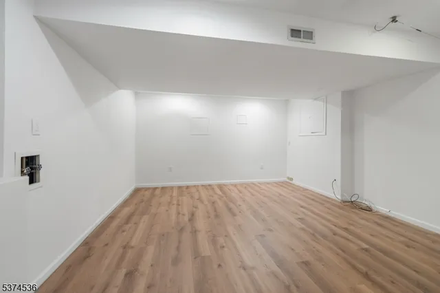 an aerial view of a house with a yard and large tree
