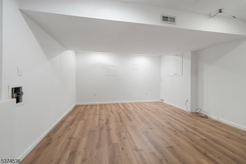 201 Dryden Road Bernardsville, NJ 07924 - Photo 38 of 48 an empty room with wooden floor and windows