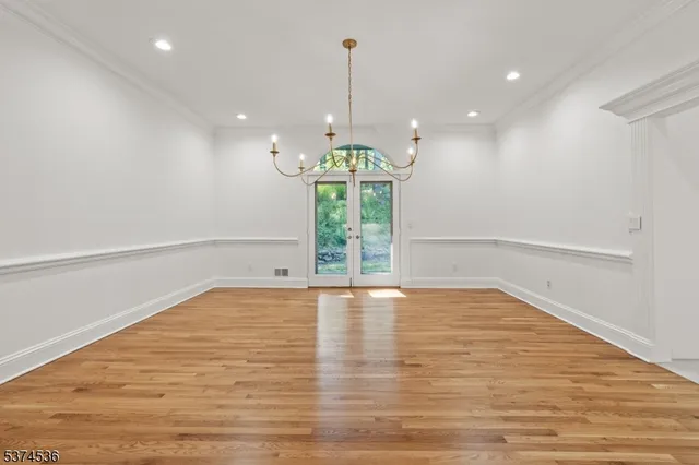 a view of a room with wooden floor and white walls
