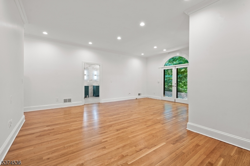 201 Dryden Road Bernardsville, NJ 07924 - Photo 10 of 48 a view of an empty room with wooden floor and a window