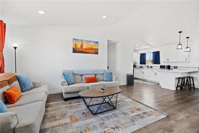a living room with furniture and kitchen view
