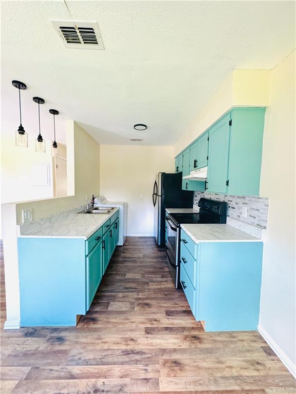 1620 West Samano Street Edinburg, TX 78539 - Photo 12 of 39 a large kitchen with stainless steel appliances a stove and a refrigerator