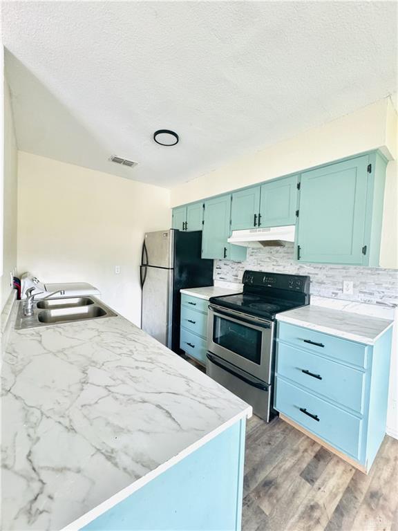 1620 West Samano Street Edinburg, TX 78539 - Photo 14 of 39 a kitchen with a stove a sink and a microwave