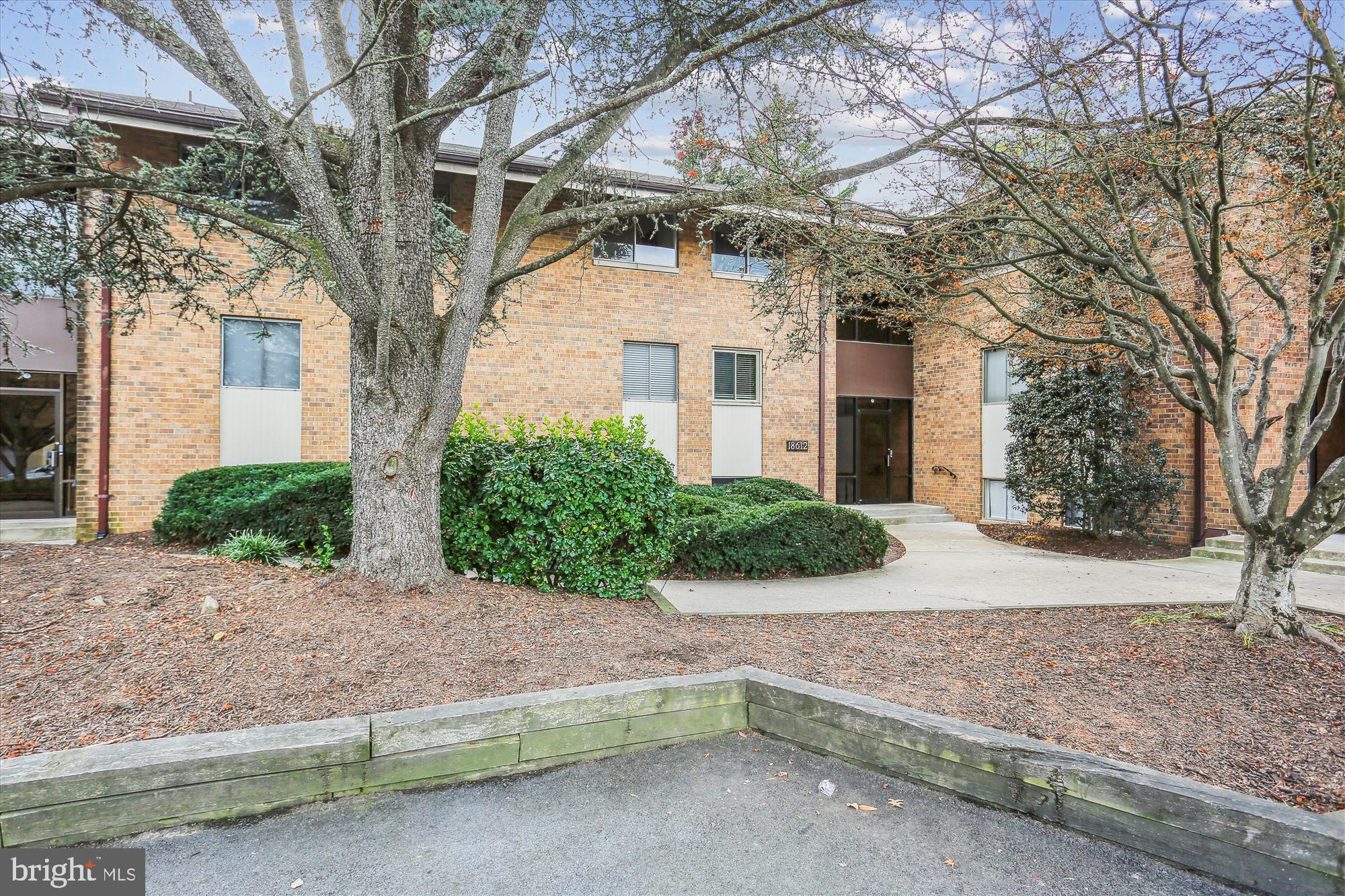 18612 Walkers Choice Road, Unit 1 Montgomery Village, MD 20886 - Photo 1 of 42 a view of a house with a yard and large tree