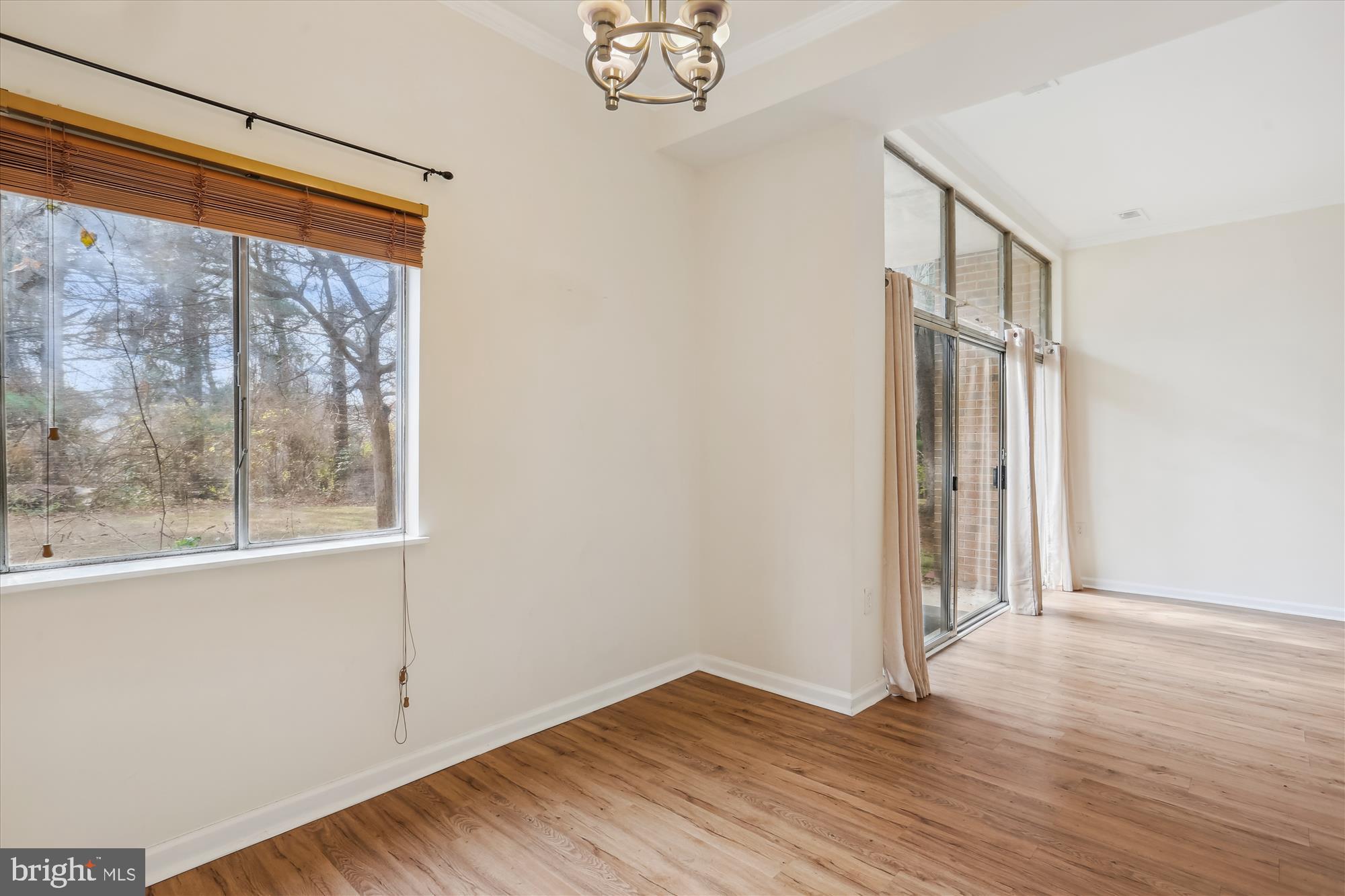 18612 Walkers Choice Road, Unit 1 Montgomery Village, MD 20886 - Photo 13 of 42 a view of empty room with wooden floor and fan
