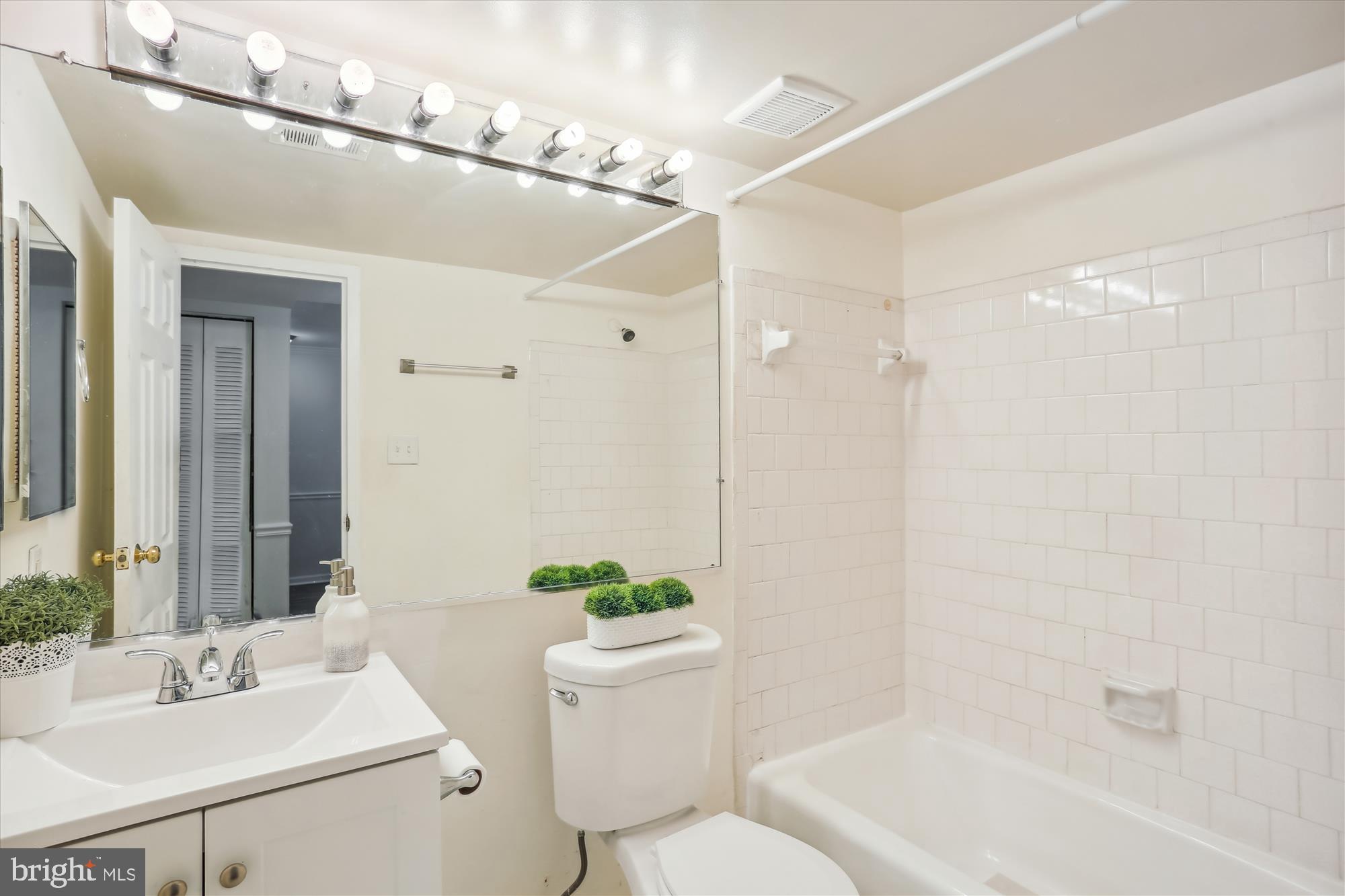 18612 Walkers Choice Road, Unit 1 Montgomery Village, MD 20886 - Photo 15 of 42 a bathroom with a sink shower and a mirror
