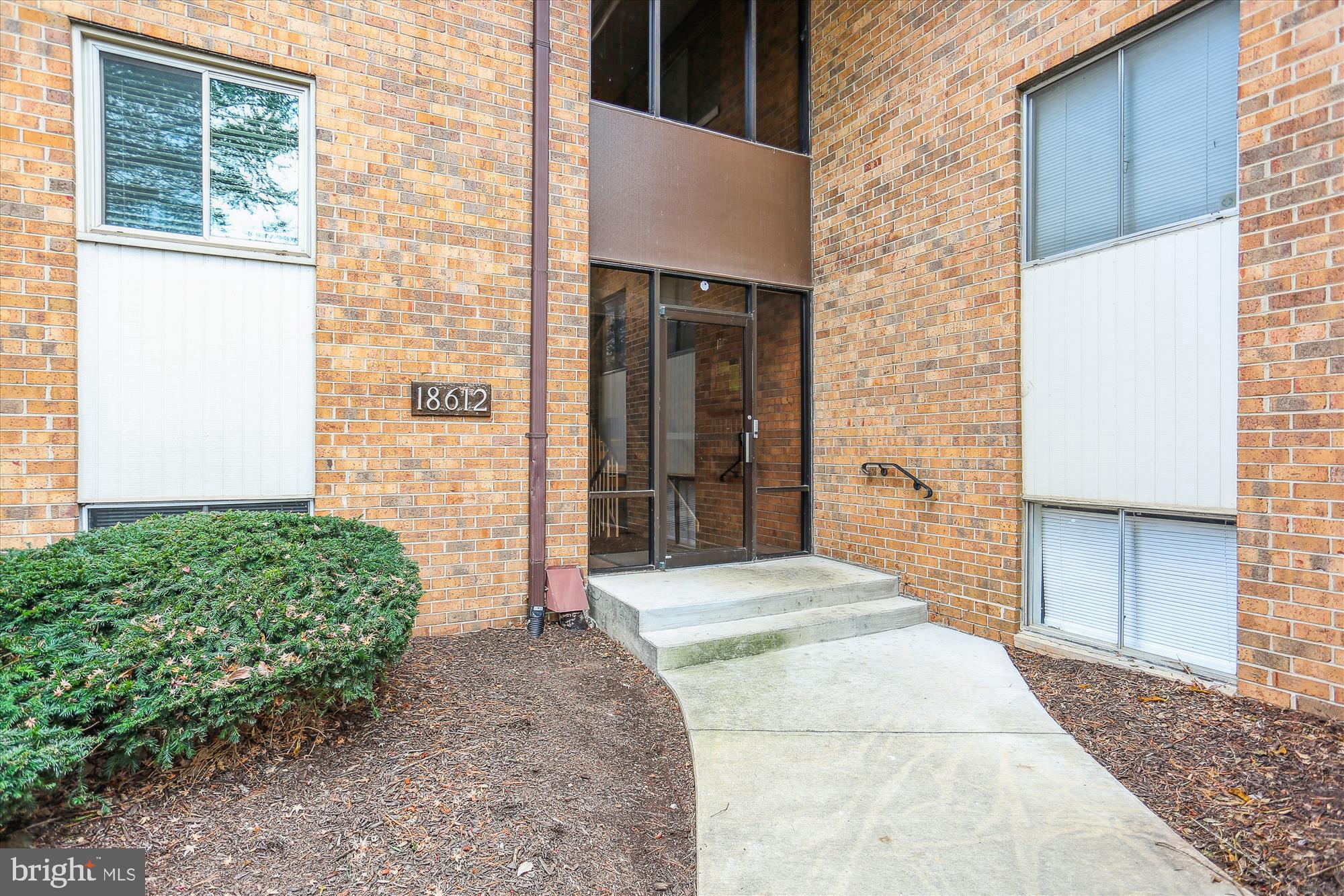 18612 Walkers Choice Road, Unit 1 Montgomery Village, MD 20886 - Photo 2 of 42 a front view of a house with a yard