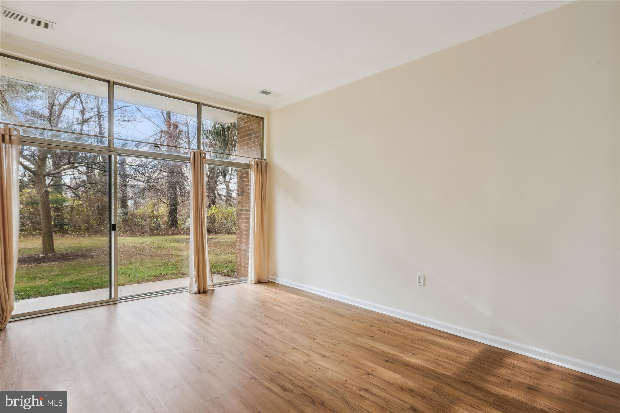 18612 Walkers Choice Road, Unit 1 Montgomery Village, MD 20886 - Photo 23 of 42 a view of an empty room with wooden floor and windows