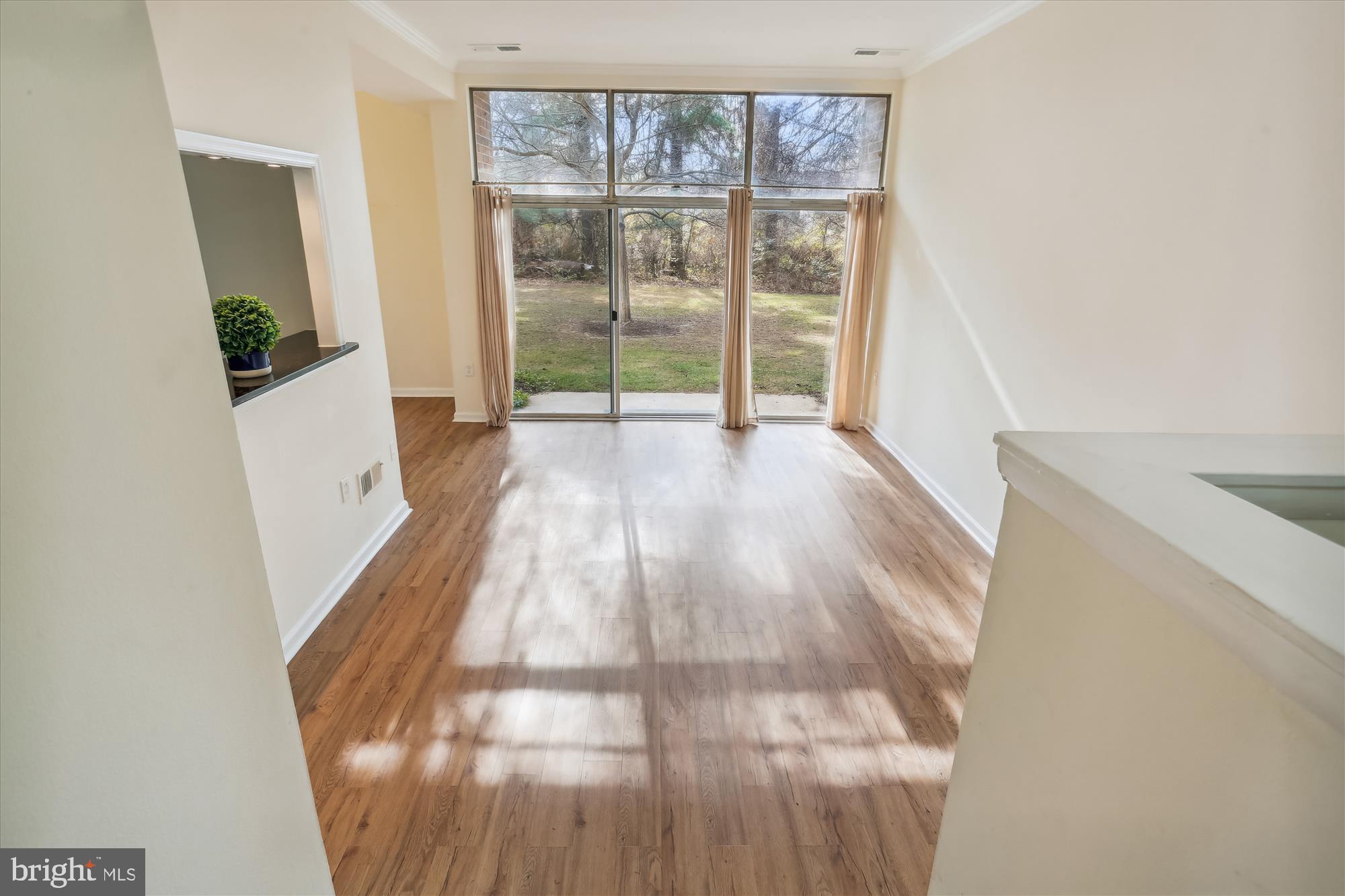 18612 Walkers Choice Road, Unit 1 Montgomery Village, MD 20886 - Photo 4 of 42 a view of a room with wooden floor and a window
