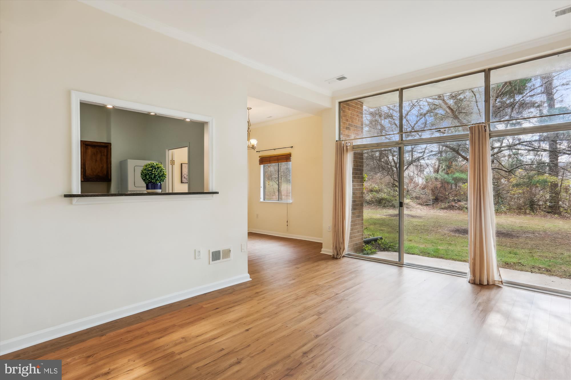 18612 Walkers Choice Road, Unit 1 Montgomery Village, MD 20886 - Photo 5 of 42 a view of an empty room with wooden floor and a window