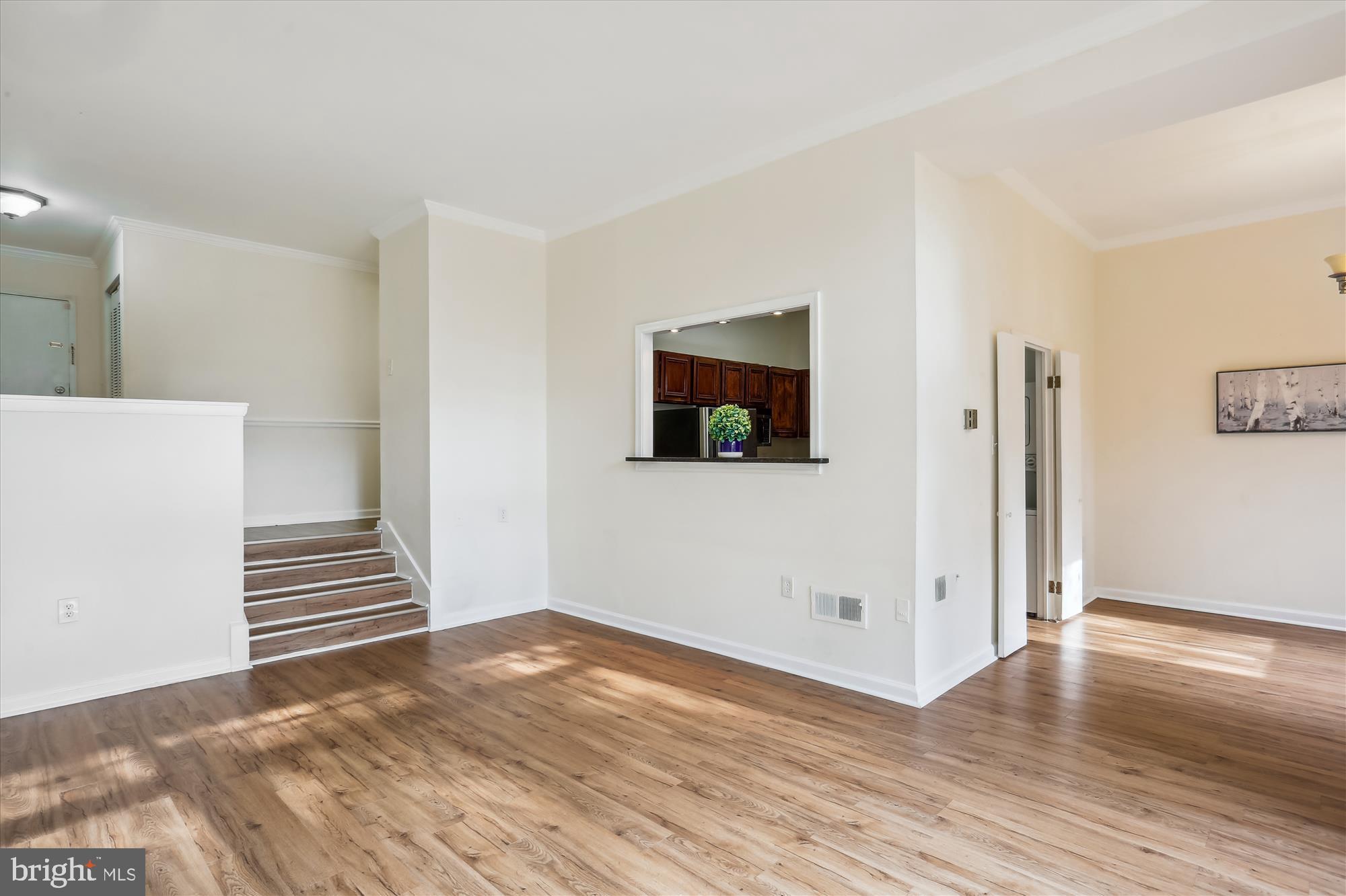 18612 Walkers Choice Road, Unit 1 Montgomery Village, MD 20886 - Photo 7 of 42 a view of an empty room with wooden floor and stairs