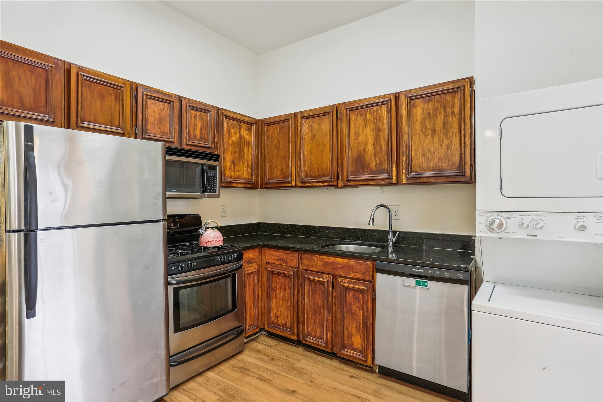 18612 Walkers Choice Road, Unit 1 Montgomery Village, MD 20886 - Photo 9 of 42 a kitchen with a refrigerator sink and cabinets