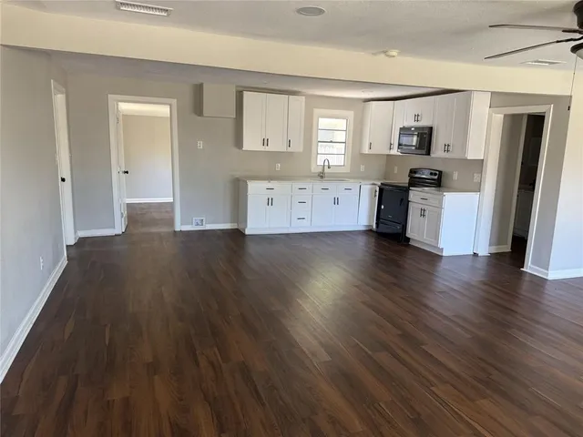 a view of a kitchen with a sink and a refrigerator