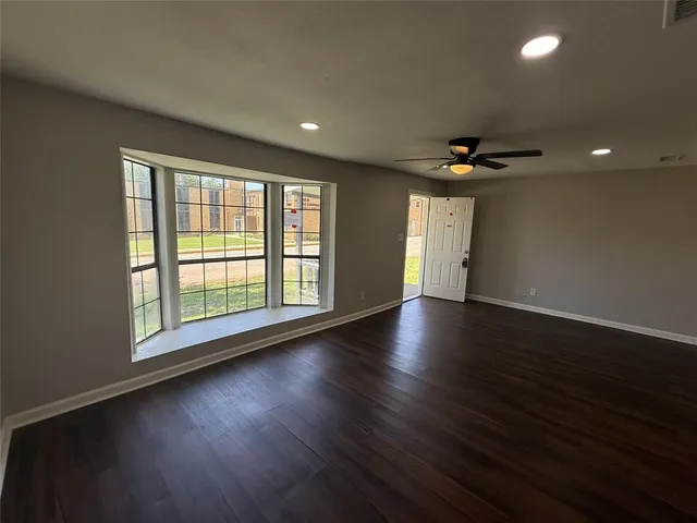a view of wooden floor and windows in a room