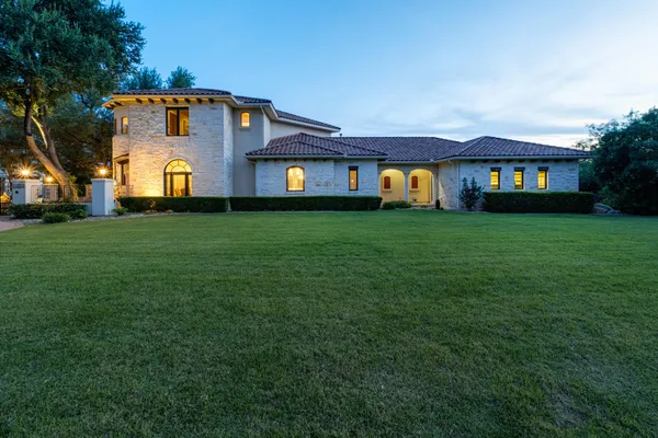 a front view of house with yard and green space