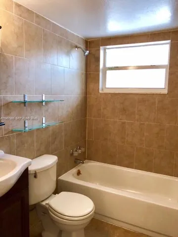 a bathroom with a toilet a sink and bathtub