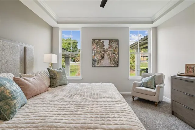 a bedroom with a large bed couch and a window