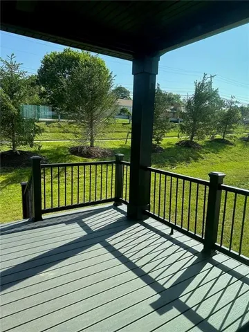 a view of a wooden deck with a yard