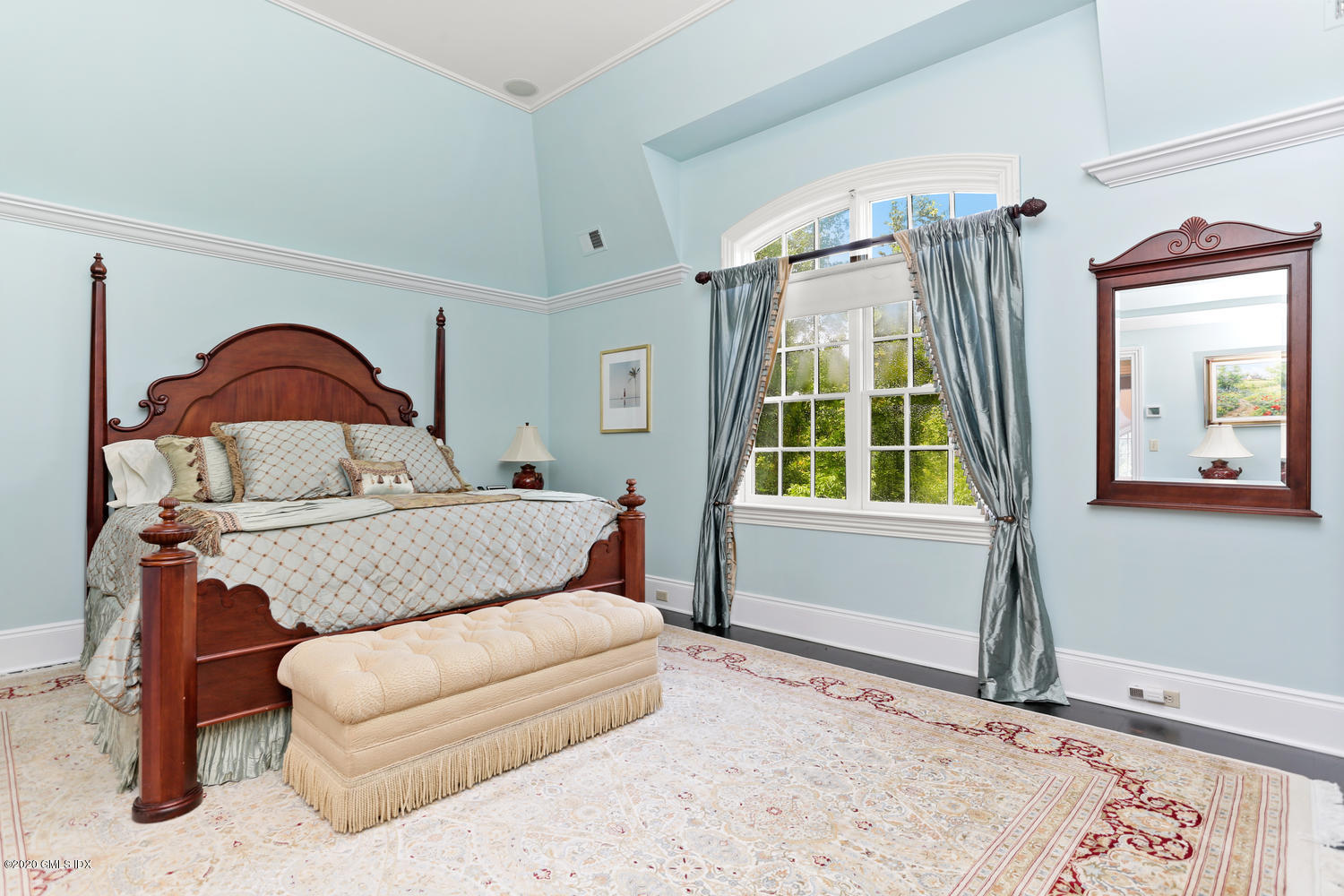 18 Chieftans Road Greenwich, CT 06831 - Photo 18 of 30 a bedroom with a bed and a window