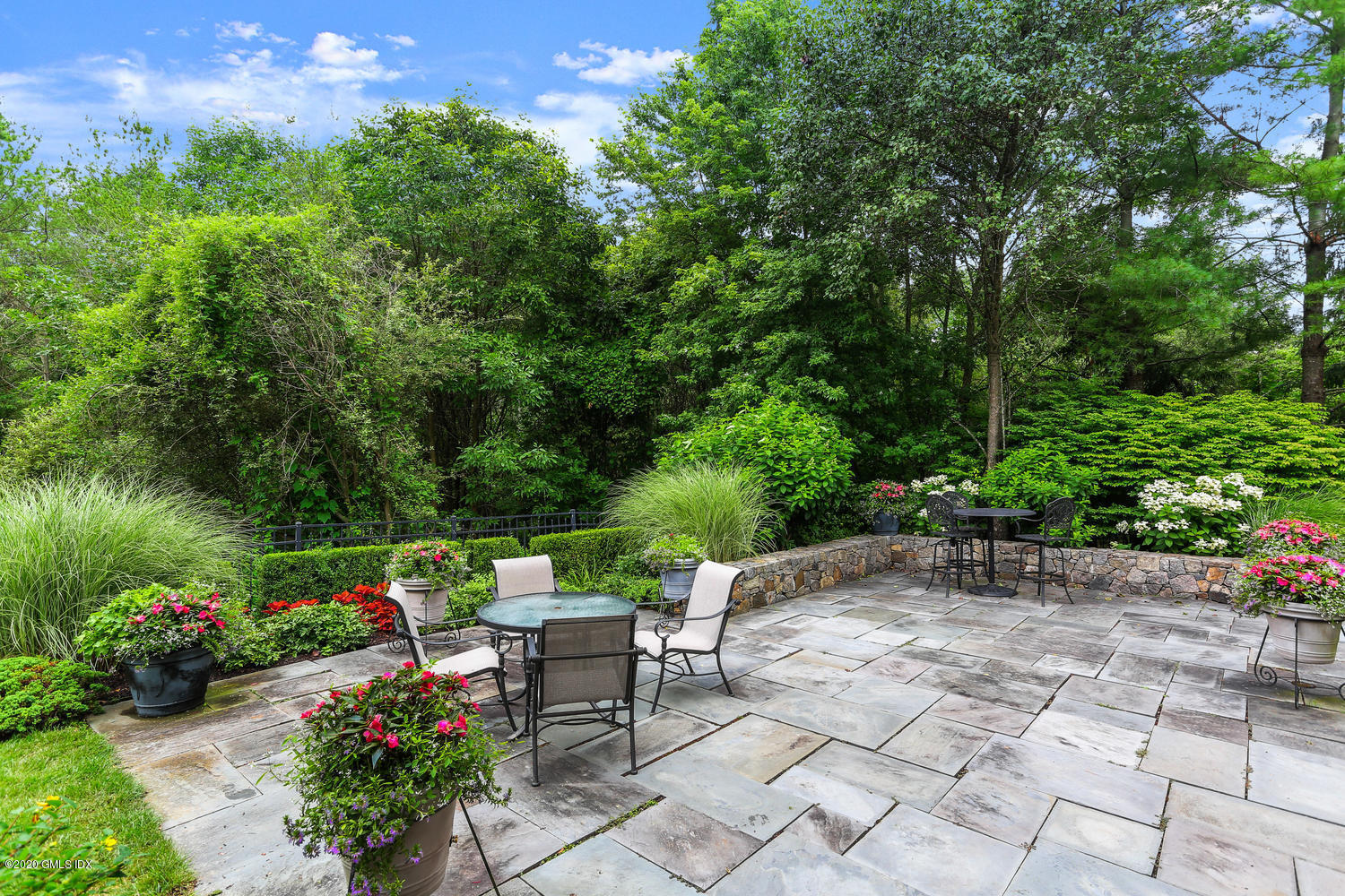 18 Chieftans Road Greenwich, CT 06831 - Photo 23 of 30 a view of a chairs and table in the garden