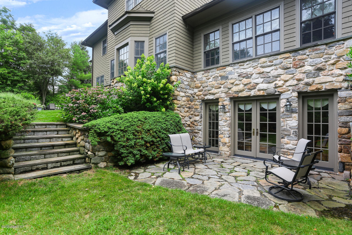 18 Chieftans Road Greenwich, CT 06831 - Photo 24 of 30 a view of a house with backyard sitting area and garden