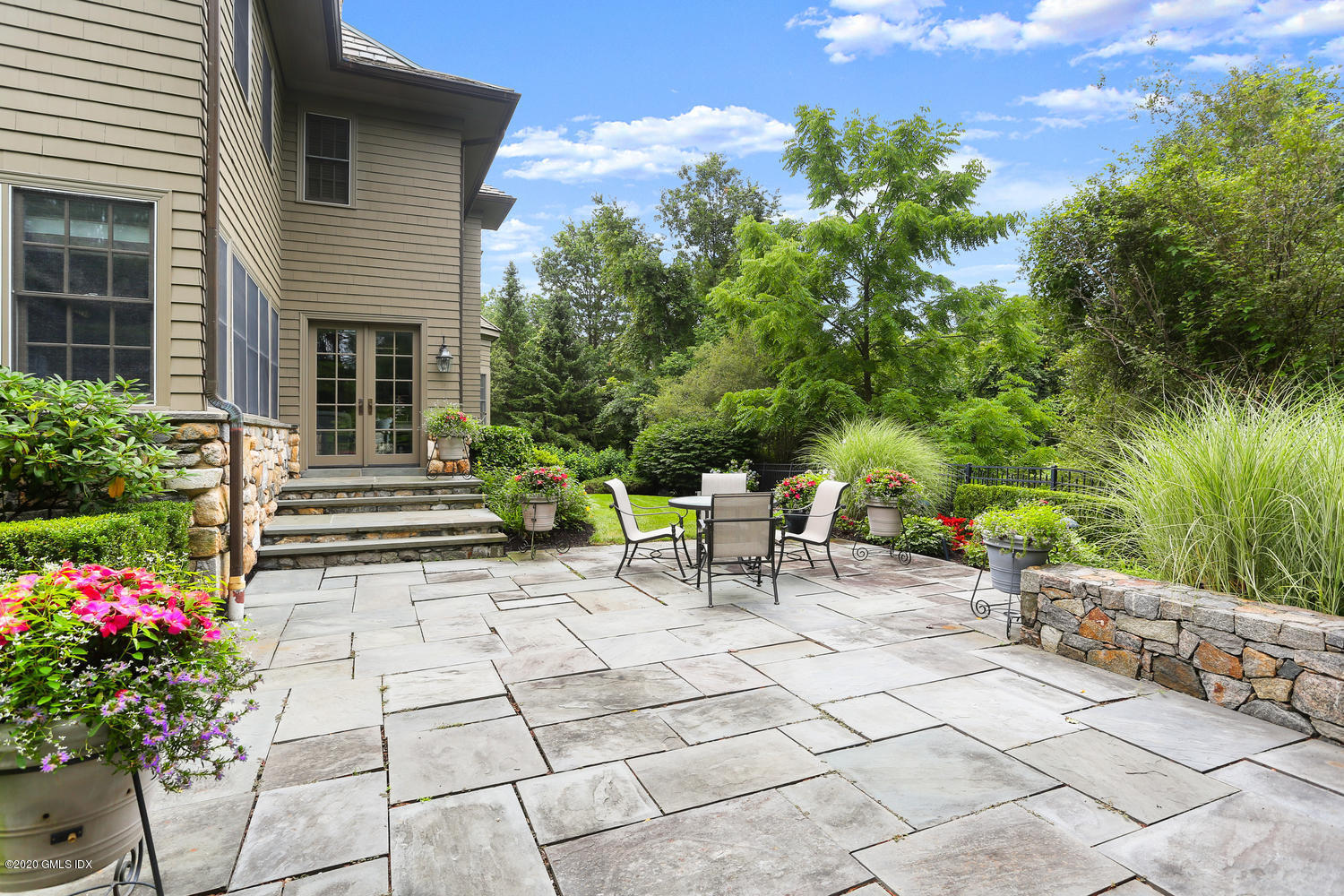 18 Chieftans Road Greenwich, CT 06831 - Photo 25 of 30 a view of a chairs and table in a back yard of the house