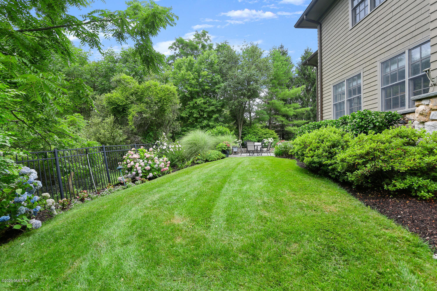 18 Chieftans Road Greenwich, CT 06831 - Photo 26 of 30 a view of a backyard with potted plants and large trees