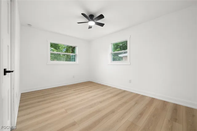 a view of an empty room with wooden floor