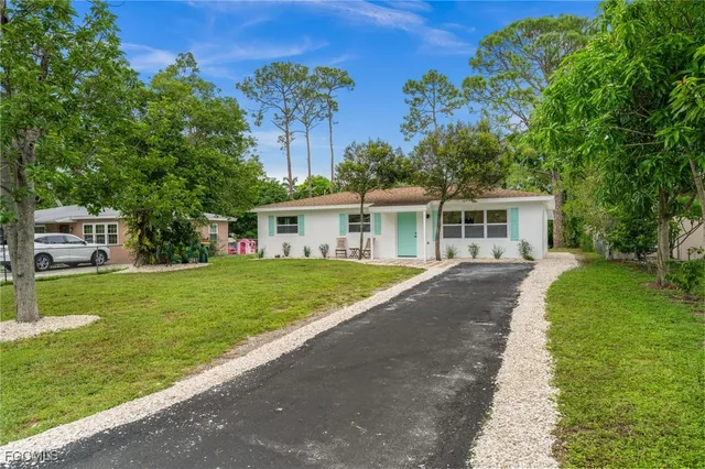 a front view of house with yard and trees