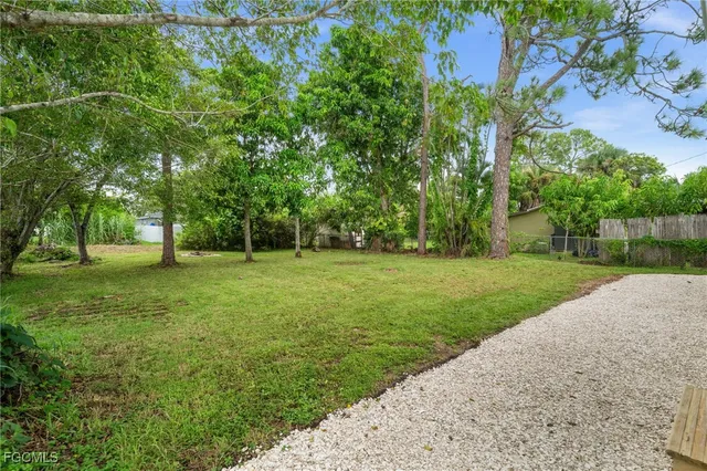 a swimming pool with outdoor seating and yard