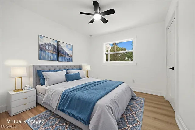 a bedroom with bed and a chandelier