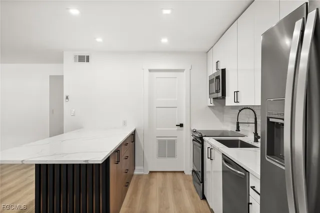 a kitchen with a sink stove and refrigerator