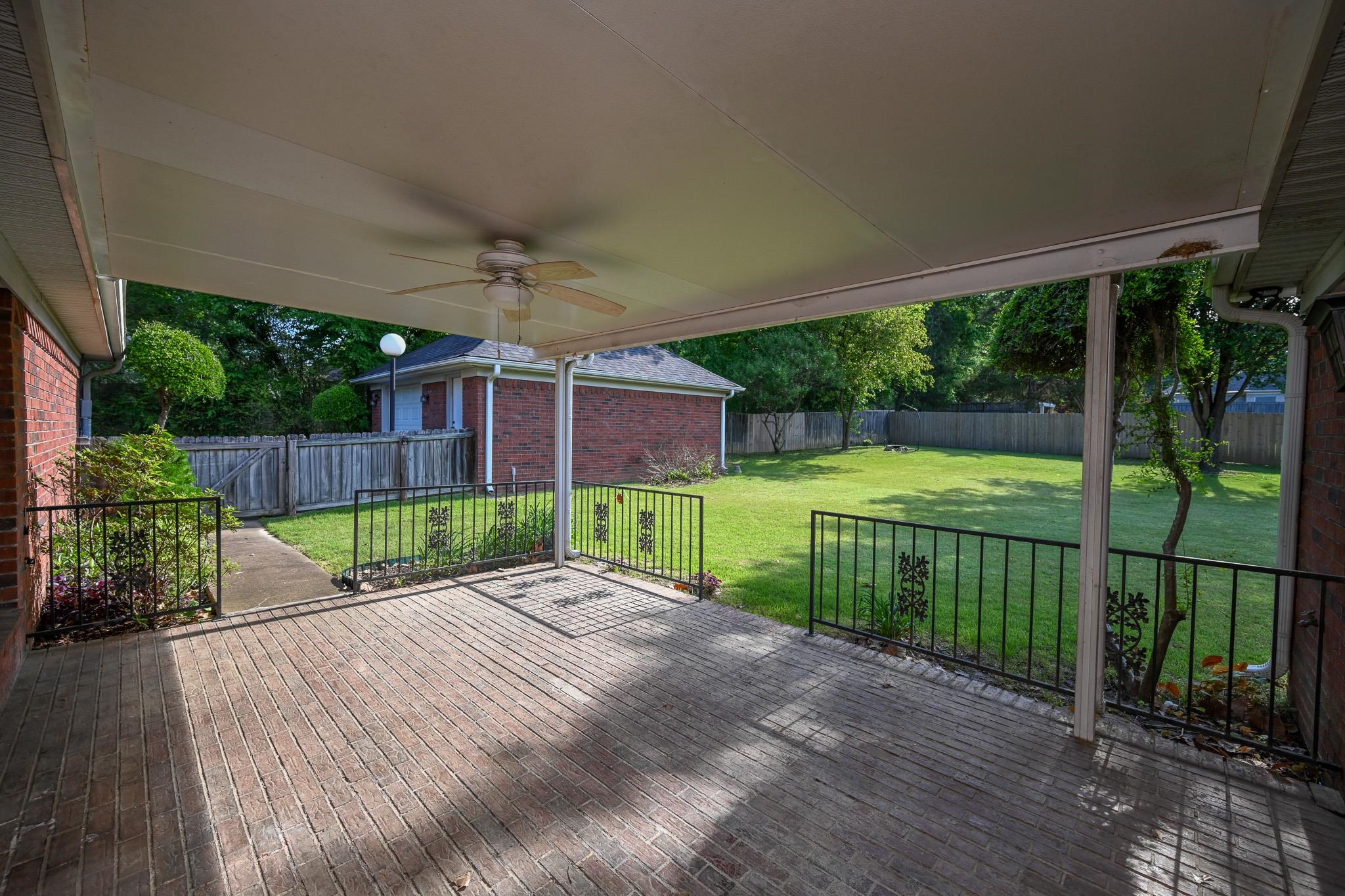 3746 Broadway Road Bartlett, TN 38135 - Photo 34 of 39 Peaceful back patio with brick flooring and ceiling fan is just waiting for those summer cookouts.
