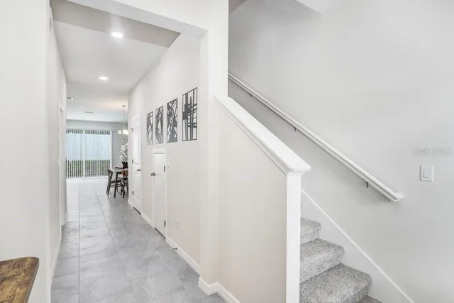 a view of entryway and hall with wooden floor