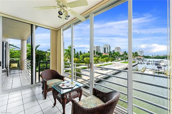 a living room with a floor to ceiling window and furniture
