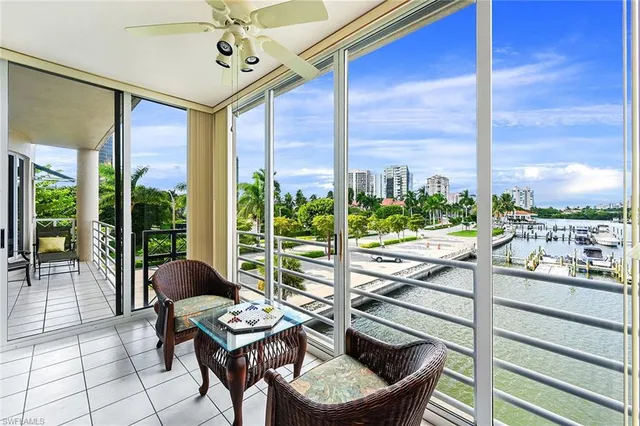 a living room with a floor to ceiling window and furniture