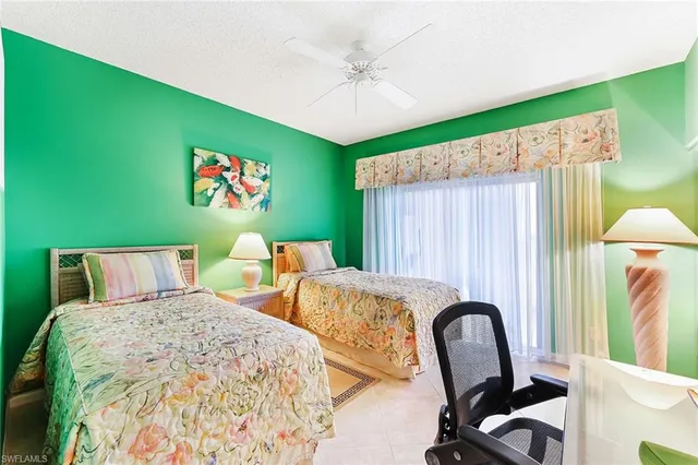 a bed room with a bed and a chair