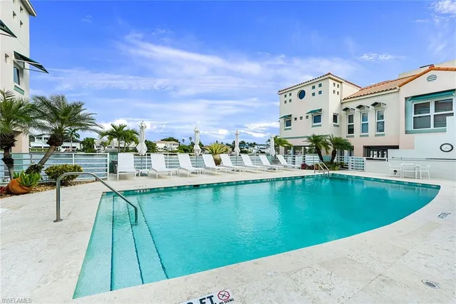 a view of swimming pool with outdoor seating and city view