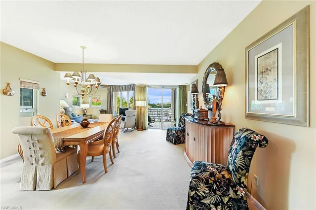 a view of a dining room with furniture and chandelier