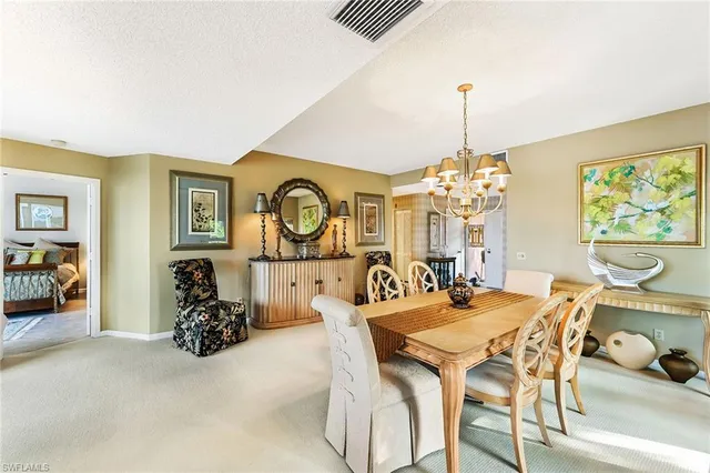 a view of a dining room with furniture and a chandelier