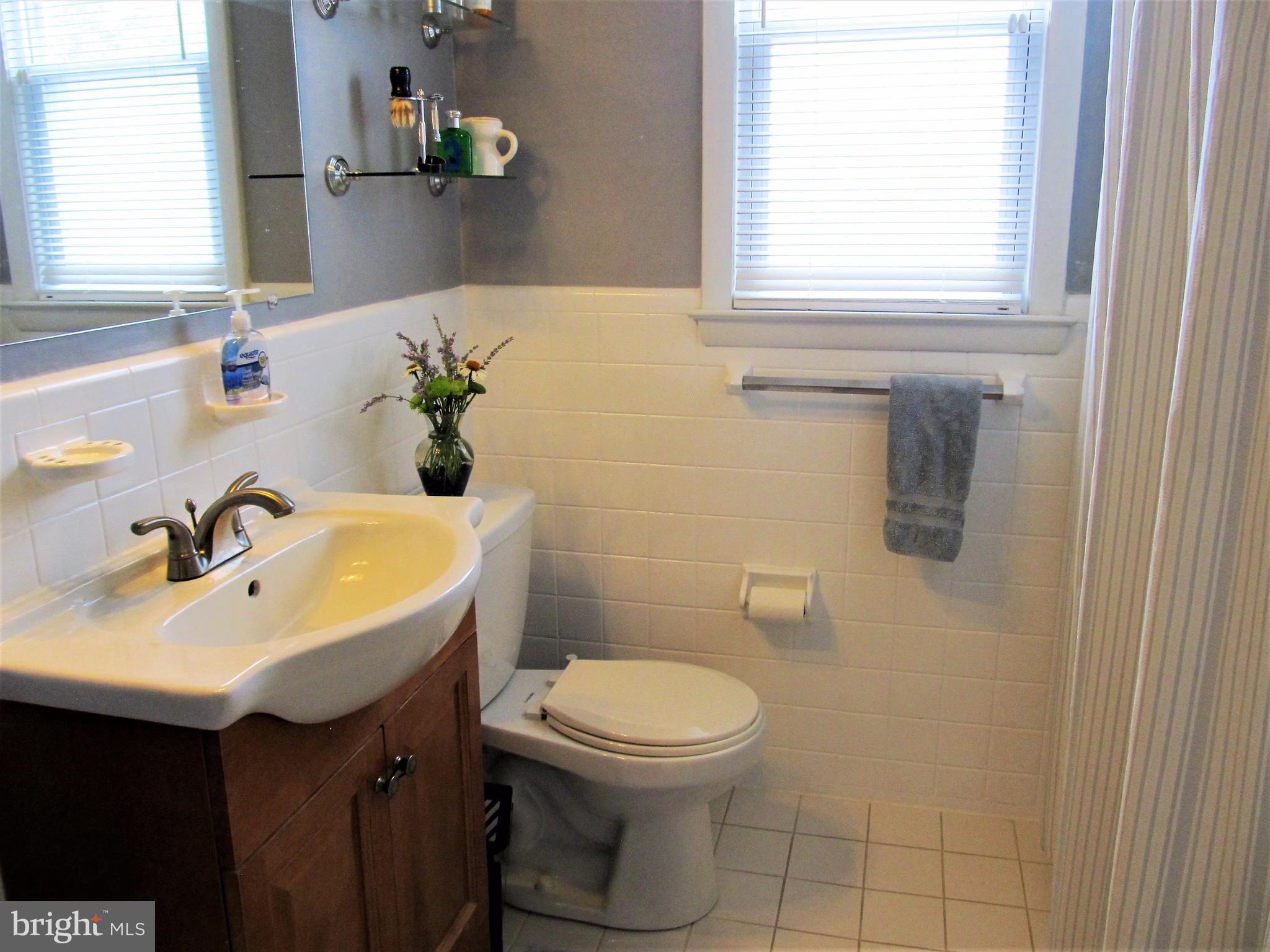 558 Fairmount Road Linthicum Heights, MD 21090 - Photo 11 of 30 a bathroom with a sink a toilet and a window