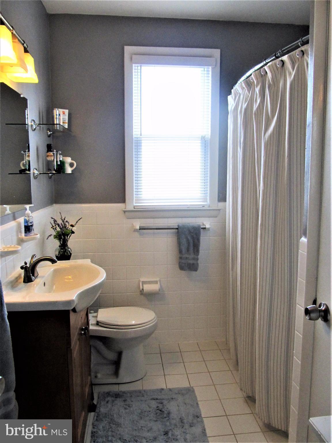 558 Fairmount Road Linthicum Heights, MD 21090 - Photo 12 of 30 a bathroom with a sink toilet and a mirror